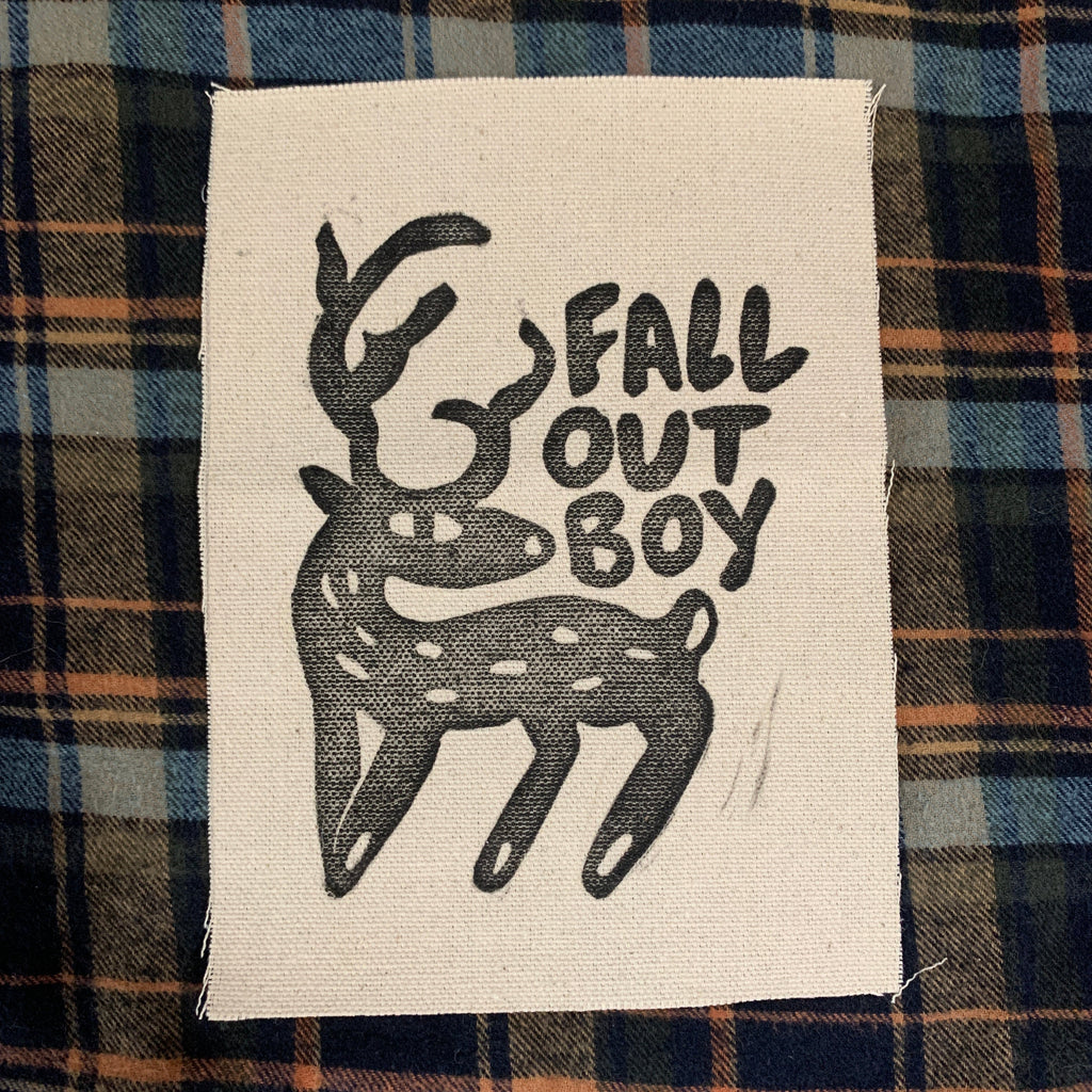 Fabric patch with 'Fall Out Boy' logo on a plaid background