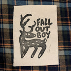 Fabric patch with 'Fall Out Boy' logo on a plaid background